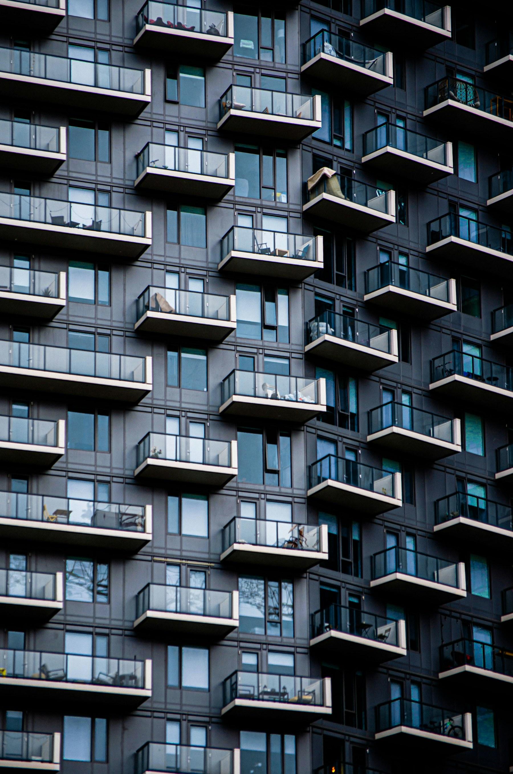 Modernist multifamily building facade with a repeating pattern of exterior balconies